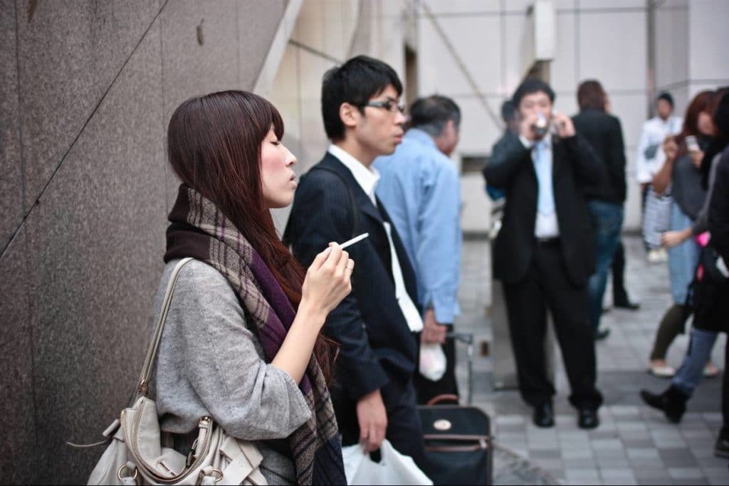 Smokers standing outside a building