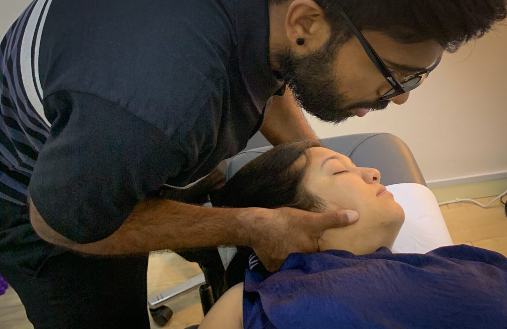 chiropractor adjusting neck of practice member