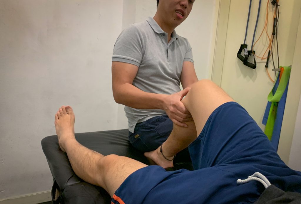 physiotherapist assessing patient's knee